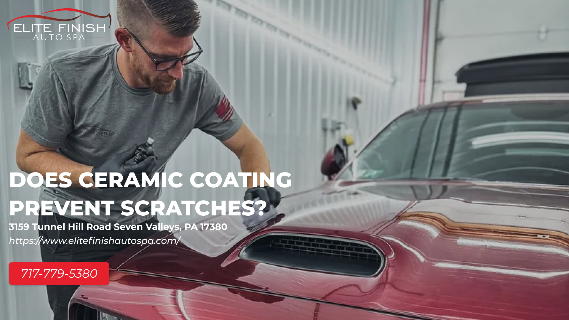 A man is polishing the hood of a red car.