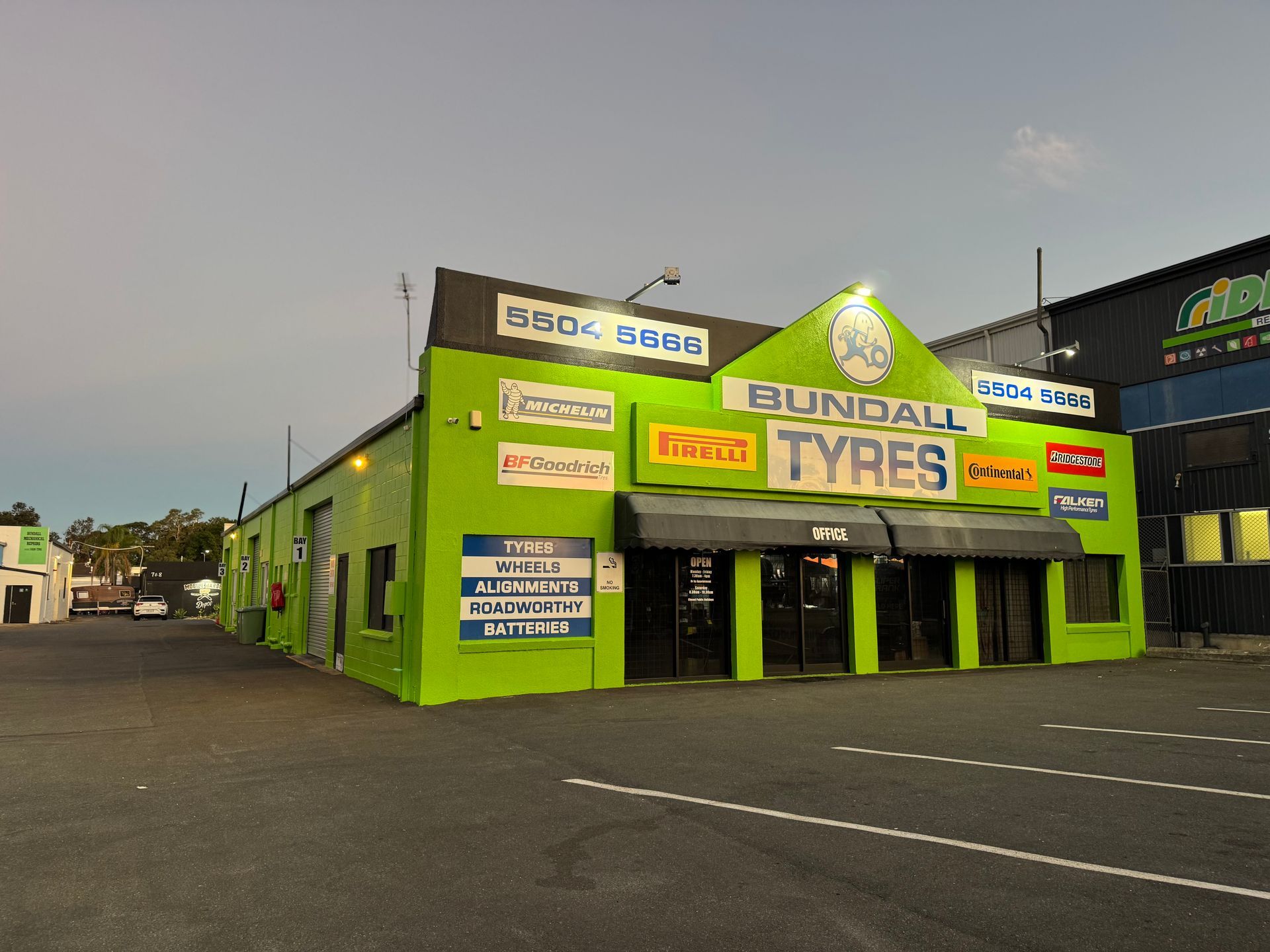 Green-painted Bundall Tyres Building — Blast It Pressure Cleaning - Gold Coast In Gold Coast, QLD