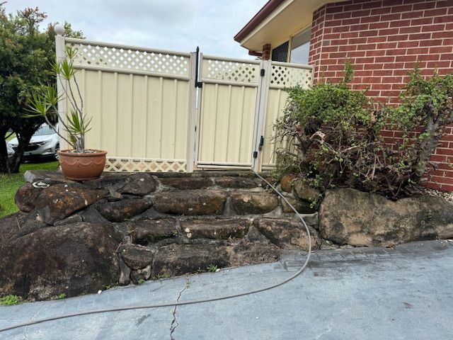 Stone Steps Lead to a Cream Fence and Gate Beside a Brick Building — Blast It Pressure Cleaning - Gold Coast In Gold Coast, QLD