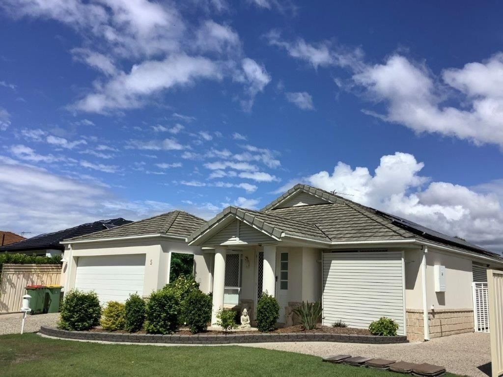 A Single-story Beige House With a White Garage Door — Blast It Pressure Cleaning - Gold Coast In Gold Coast, QLD