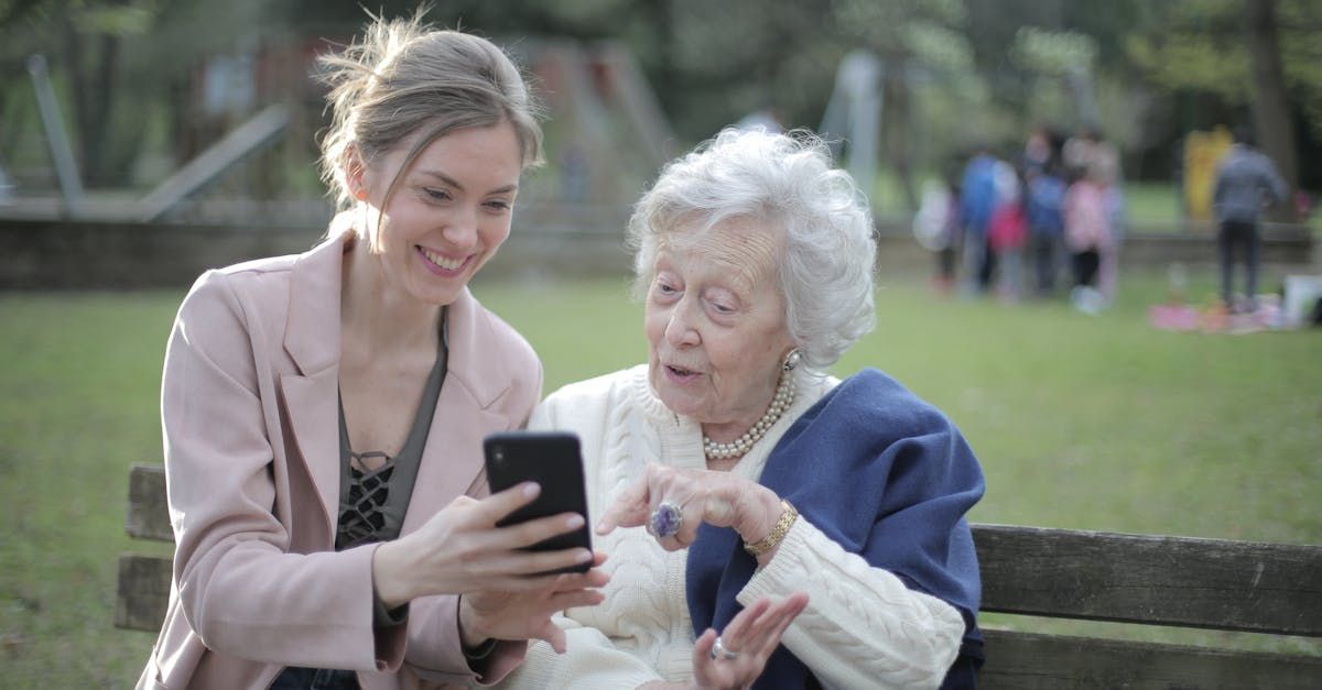 Mother and daughter looking at text messaging image.