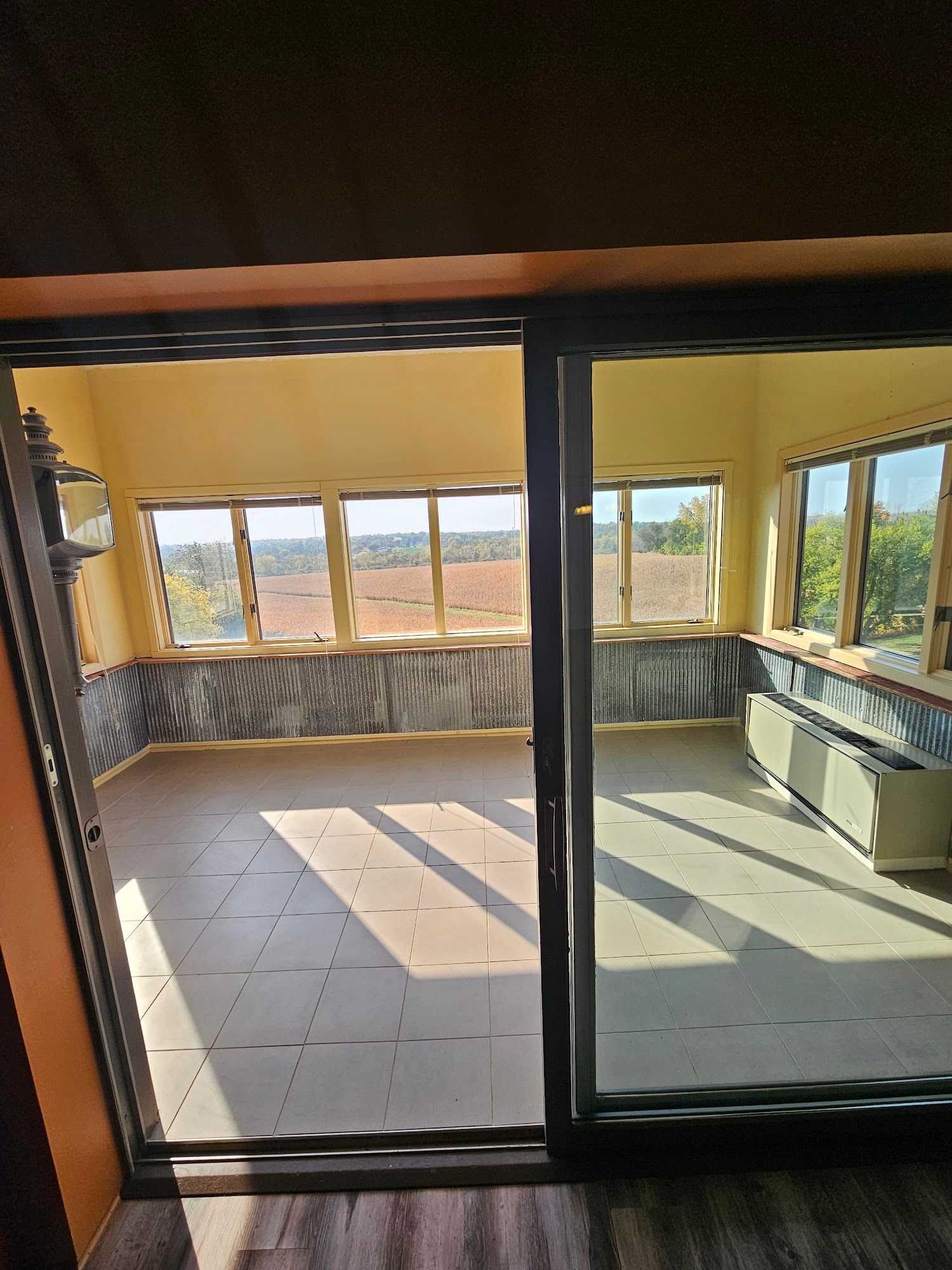 A room with a lot of windows and a sliding glass door