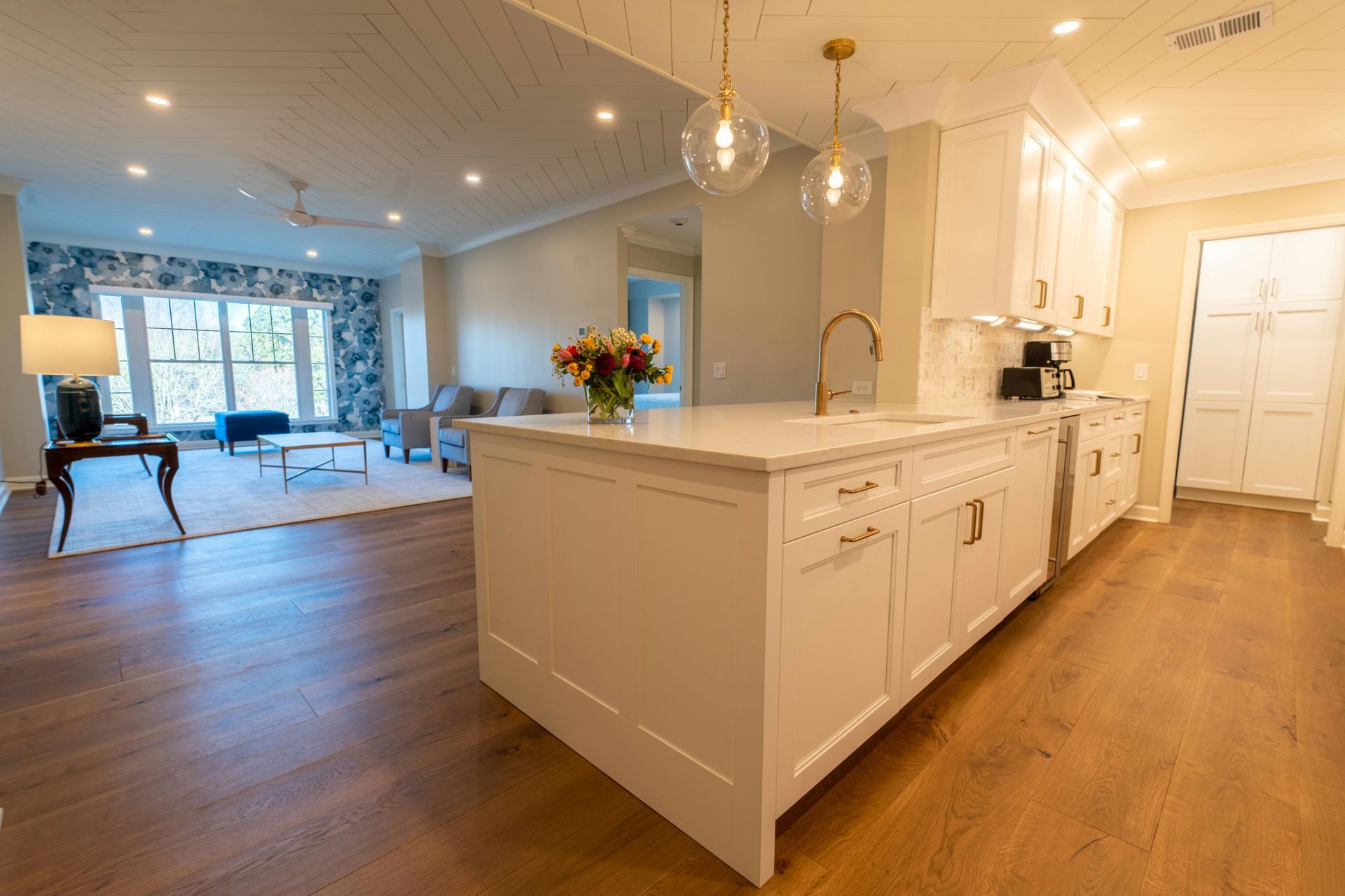 A bathroom with two sinks , a toilet , and a walk in shower.