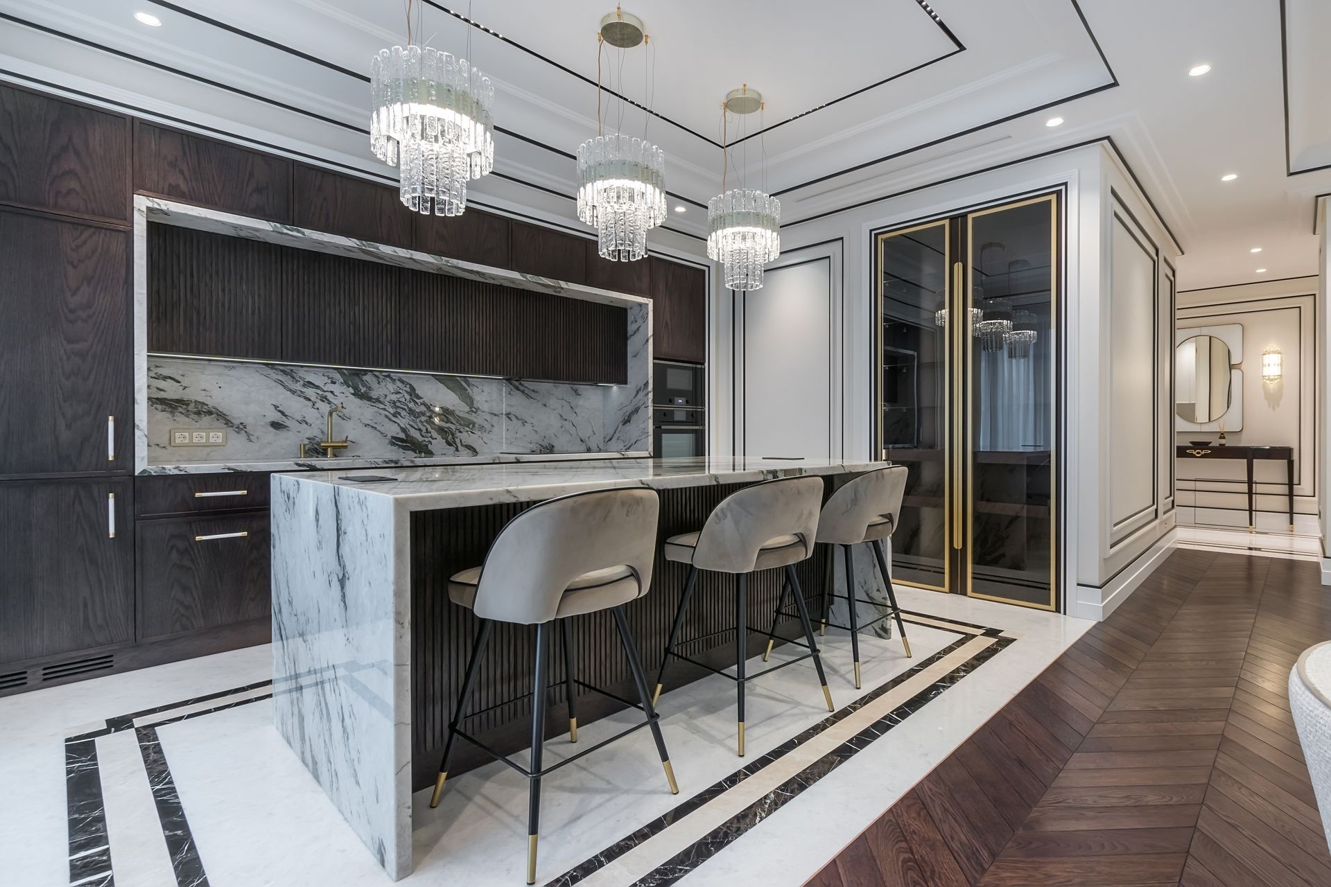 A kitchen with white cabinets , stainless steel appliances , a sink , and a large island.