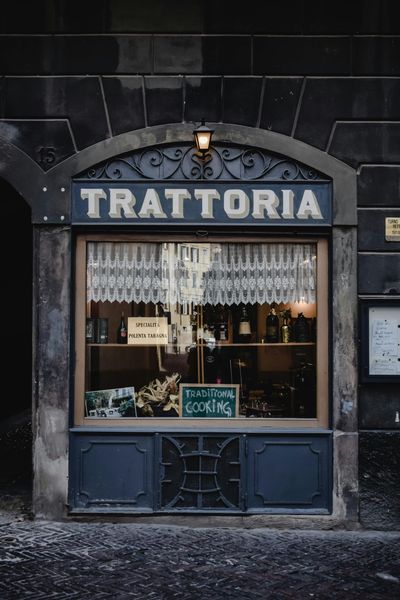 Trattoria storefront with dark blue trim,