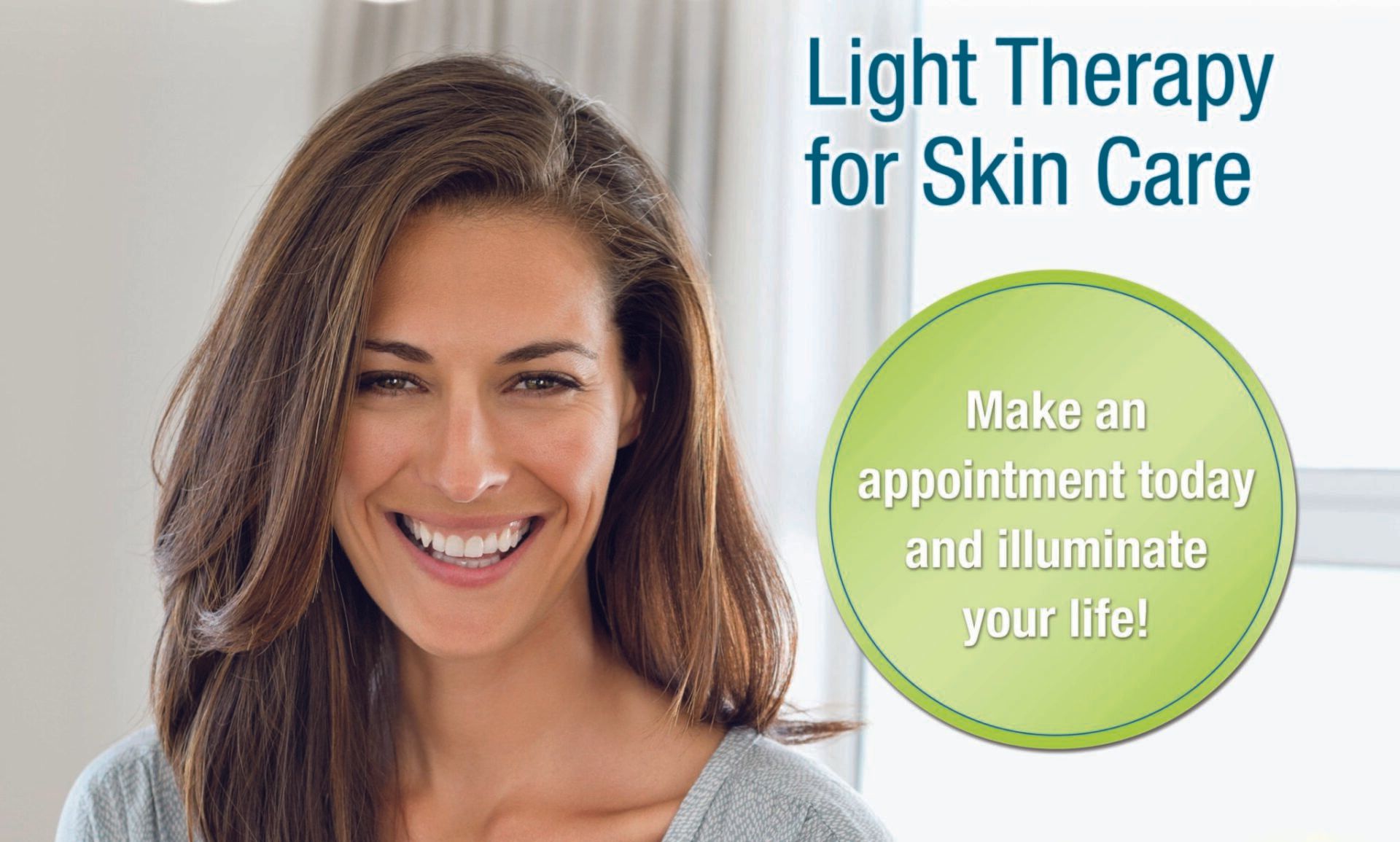 A woman is smiling in front of a sign that says light therapy for skin care