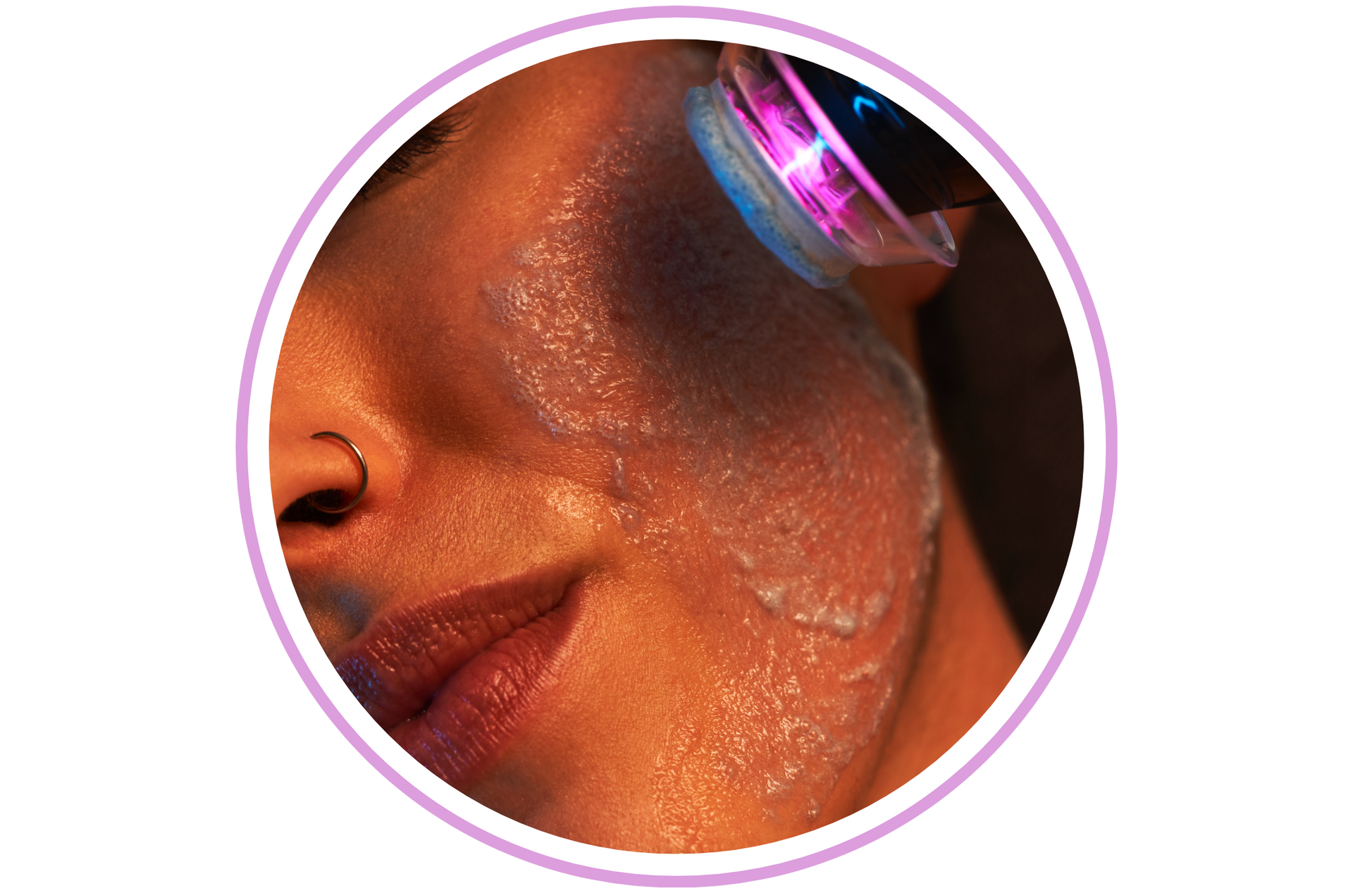 Person receiving facial treatment with glowing light device.