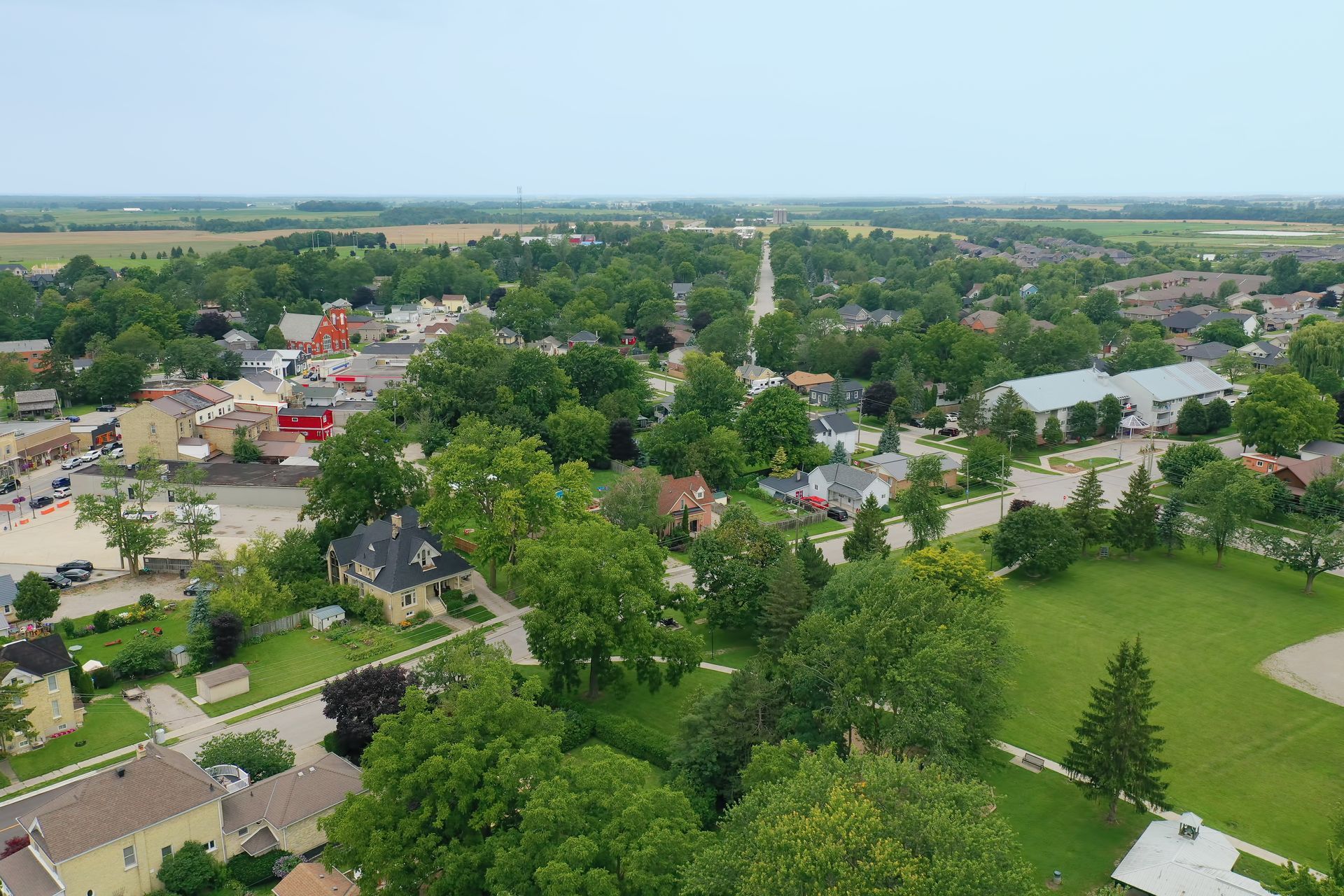 an aerial view of a small town with lots of houses and trees