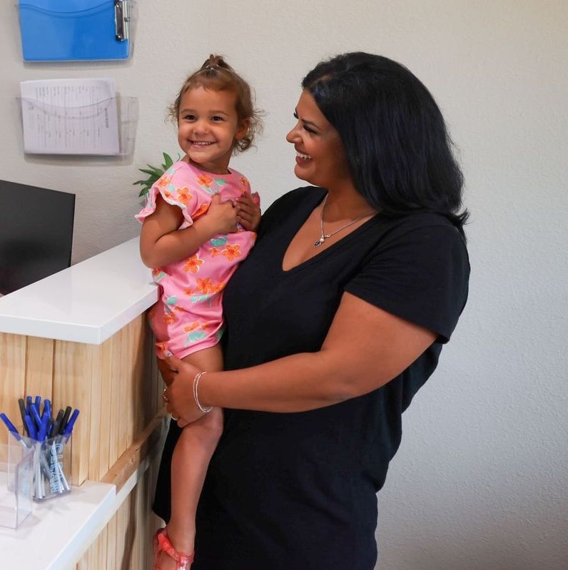 Smiling parent holding her child