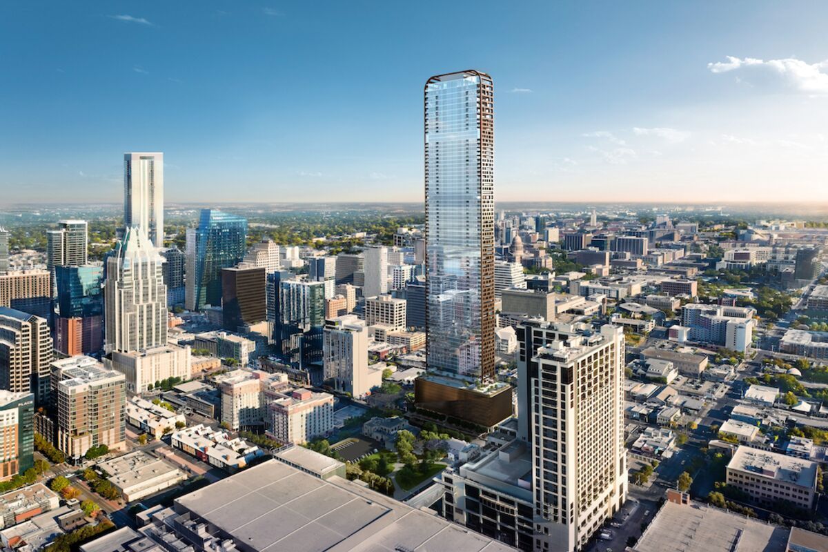 An aerial view of the Austin skyline, featuring a tall, glass-faced skyscraper rising above the surrounding buildings.