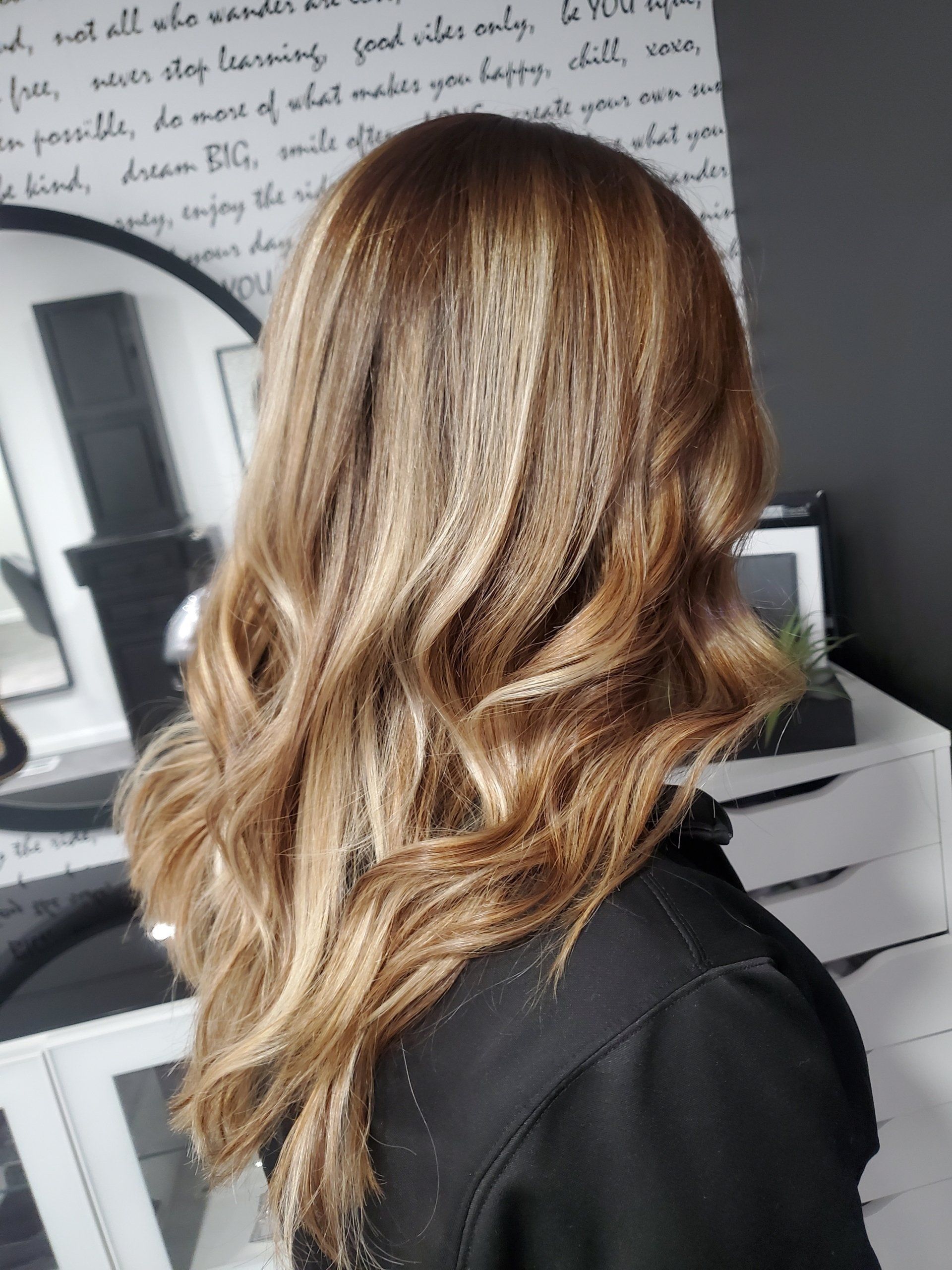 Woman with wavy, highlighted blonde and brown hair.