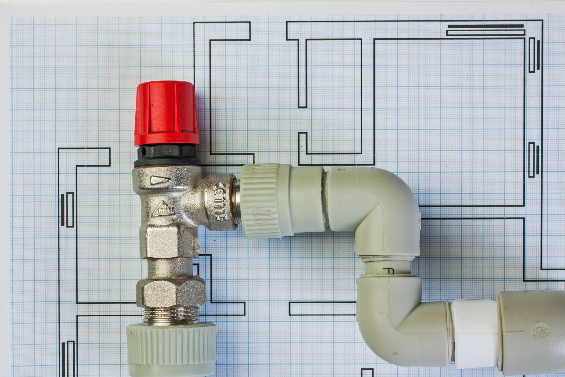 A close up of a valve and pipe on a blueprint.