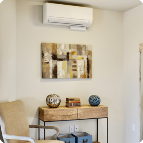 A living room with a painting on the wall above a table