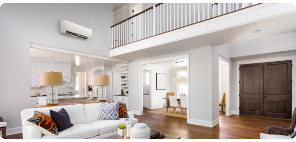 A living room with a white couch and a balcony.