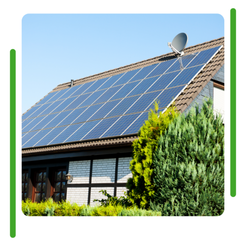 Solar panels on a residential roof, with a satellite dish, against a blue sky.