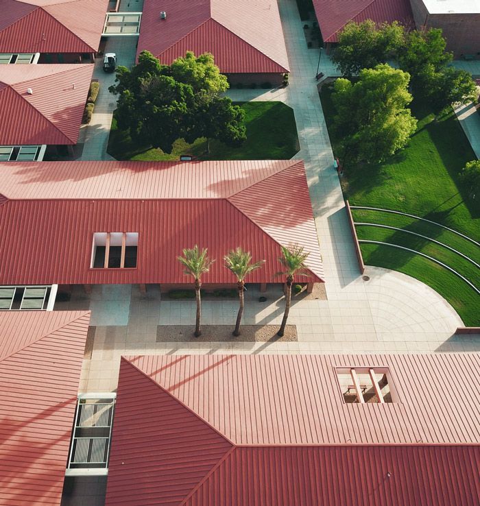 Buildings With Red Metal Roof — Professional Roofer in Alice River, QLD