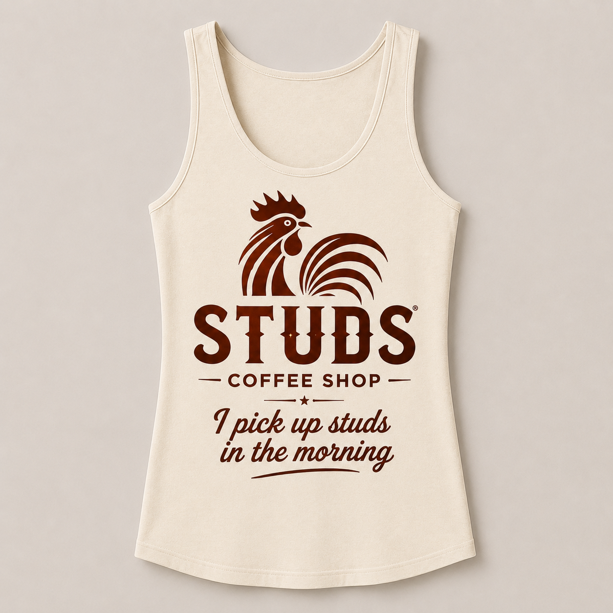 Cream tank top with coffee shop graphic and text: “STUDS Coffee Shop” and “I pick up studs in the morning”