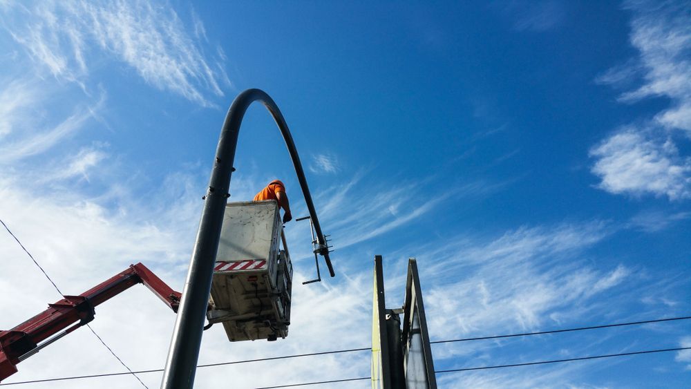 A man is in a crane lifted in the air — SEP Electrical Pty Ltd in Towradgi, NSW
