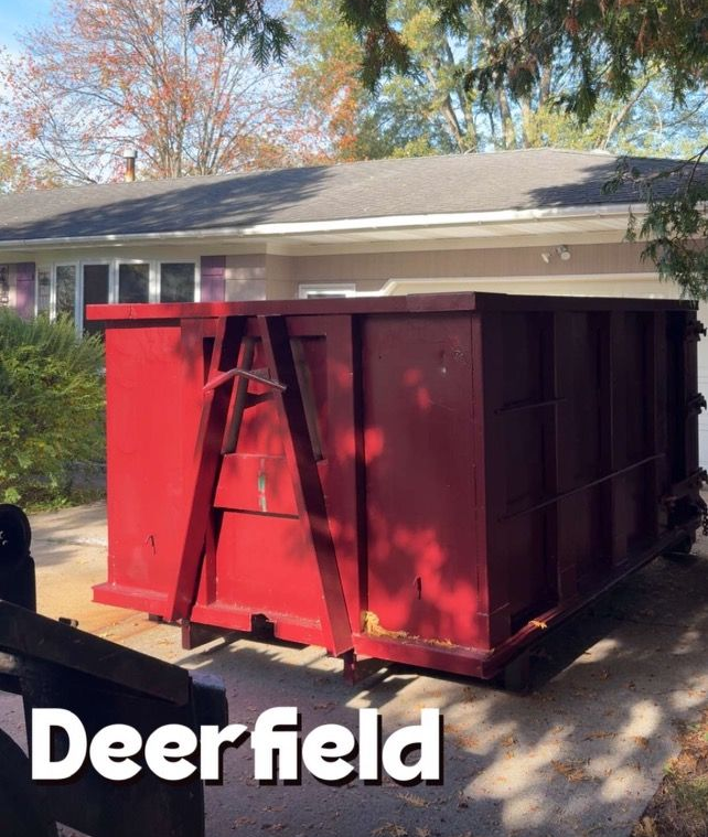 A dump truck is parked in a parking lot next to a trailer.