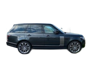 Dark gray Range Rover SUV parked on a paved driveway in front of a house with a red roof and a green lawn.