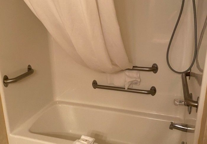 A bathroom with a bathtub and a shower curtain.