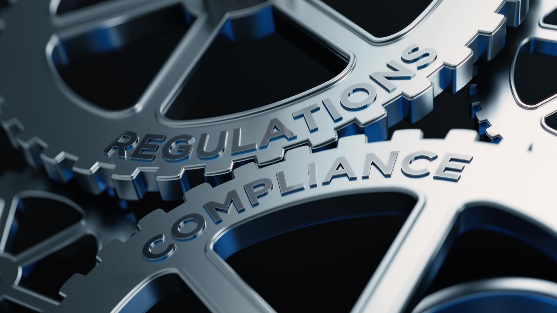 Machine cogs with the words 'Regulations' and 'Compliance'