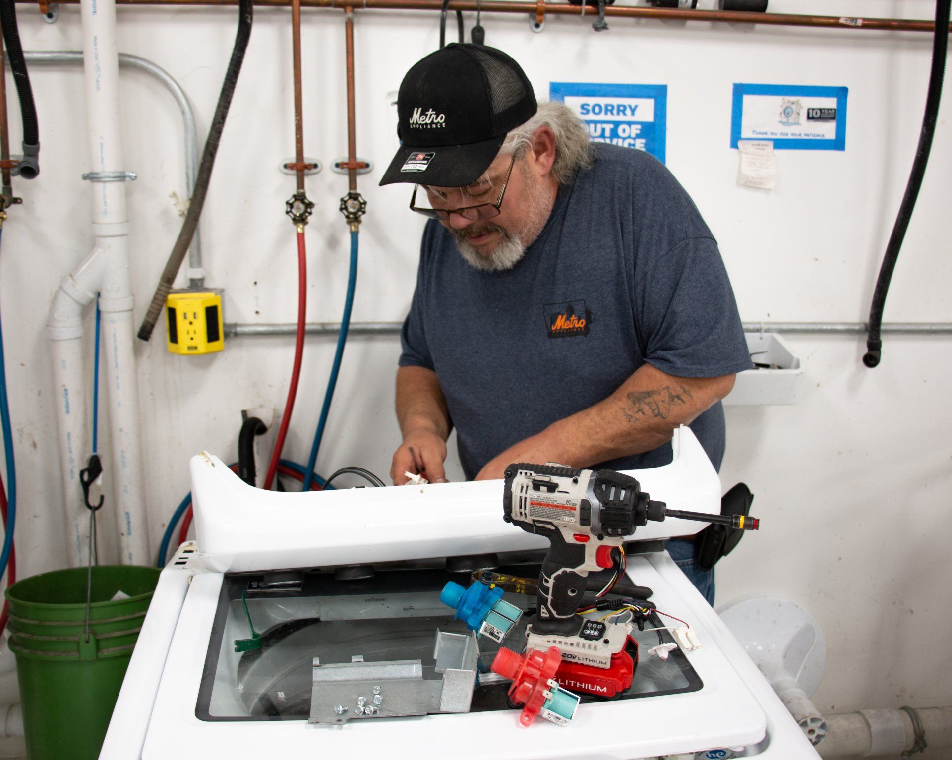 technician fixing a washing machine technician fixing a washing machine