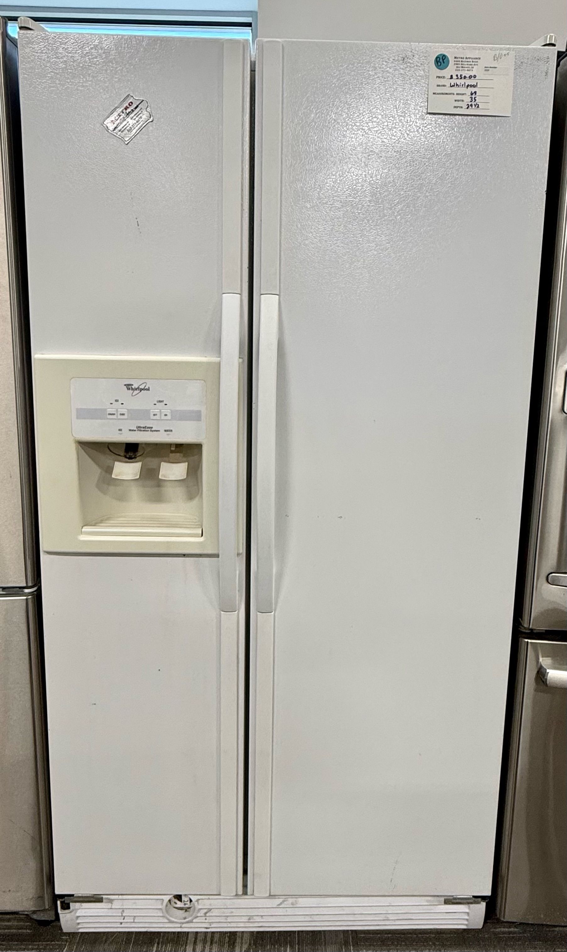 White side-by-side refrigerator with water and ice dispenser in a store display