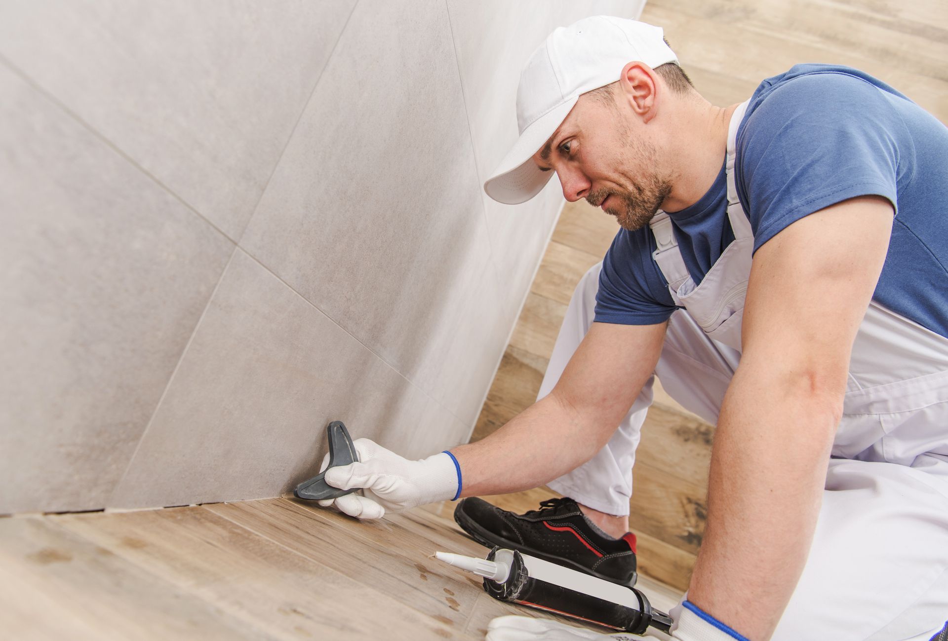 A man finishing a bathroom remodeling.
