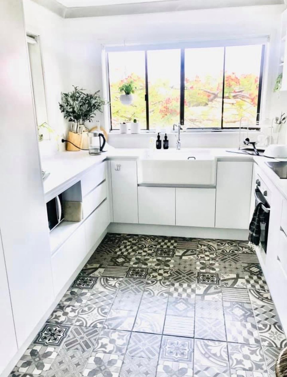 A Kitchen With White Cabinets , a Sink , and a Window — Scott Graham Building Services In Bilambil Heights, NSW