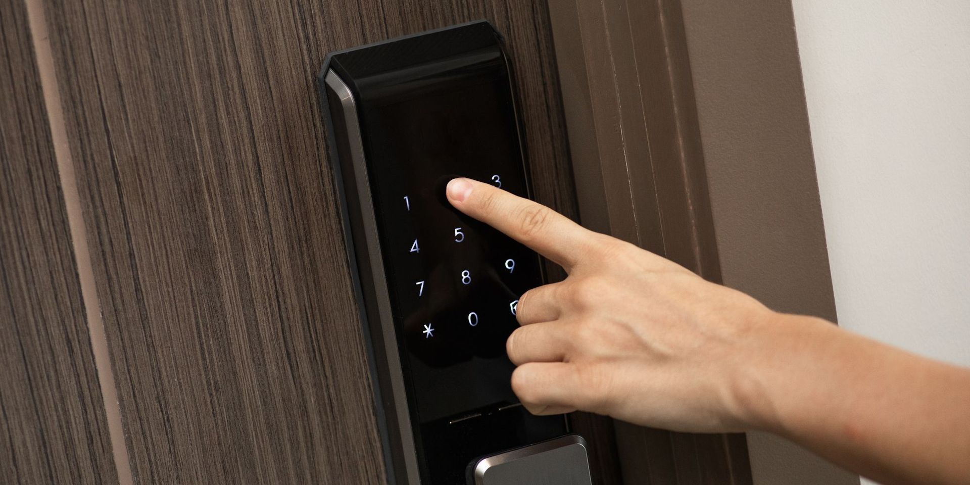 Finger extended to touch number on keyless entry door at Seabirds Motel