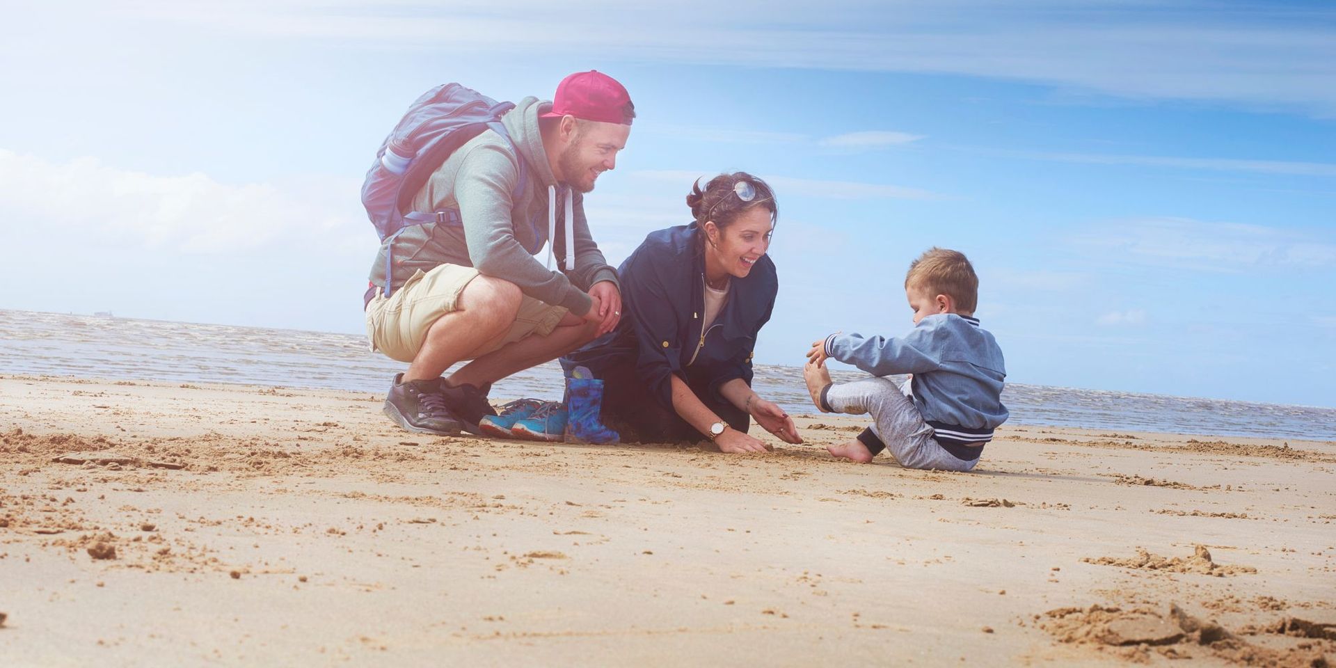Family enjoying quality time together on Kure Beach, with gentle waves and soft sand.