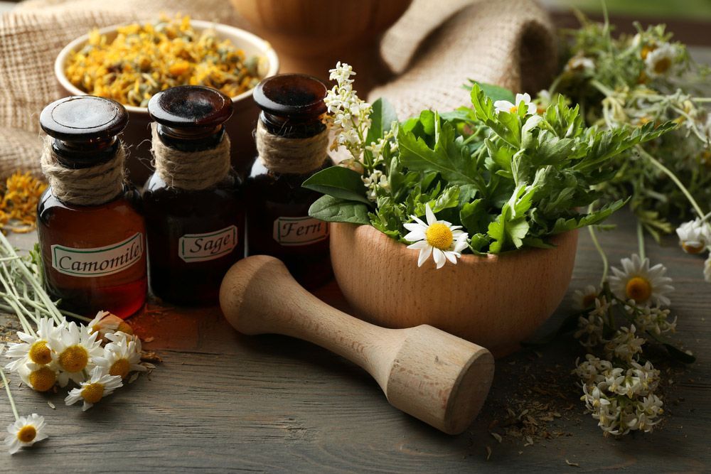Herbs, Berries And Flowers With Mortar, On Wooden Table Background — Julie Taylor Naturopath in Hervey Bay, QLD