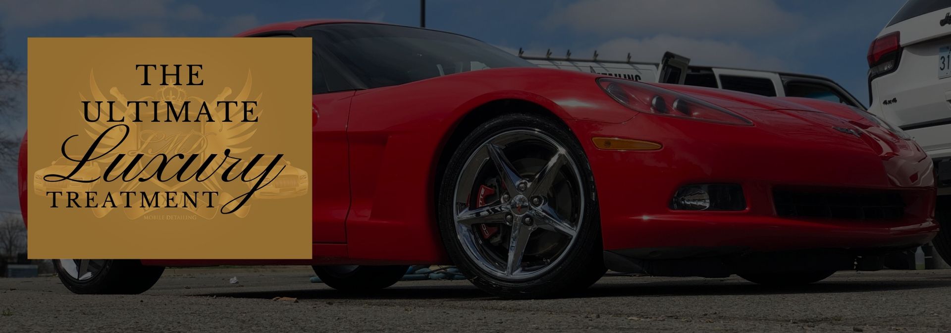 Red sports car with gold text banner reading “The Ultimate Luxury Treatment”
