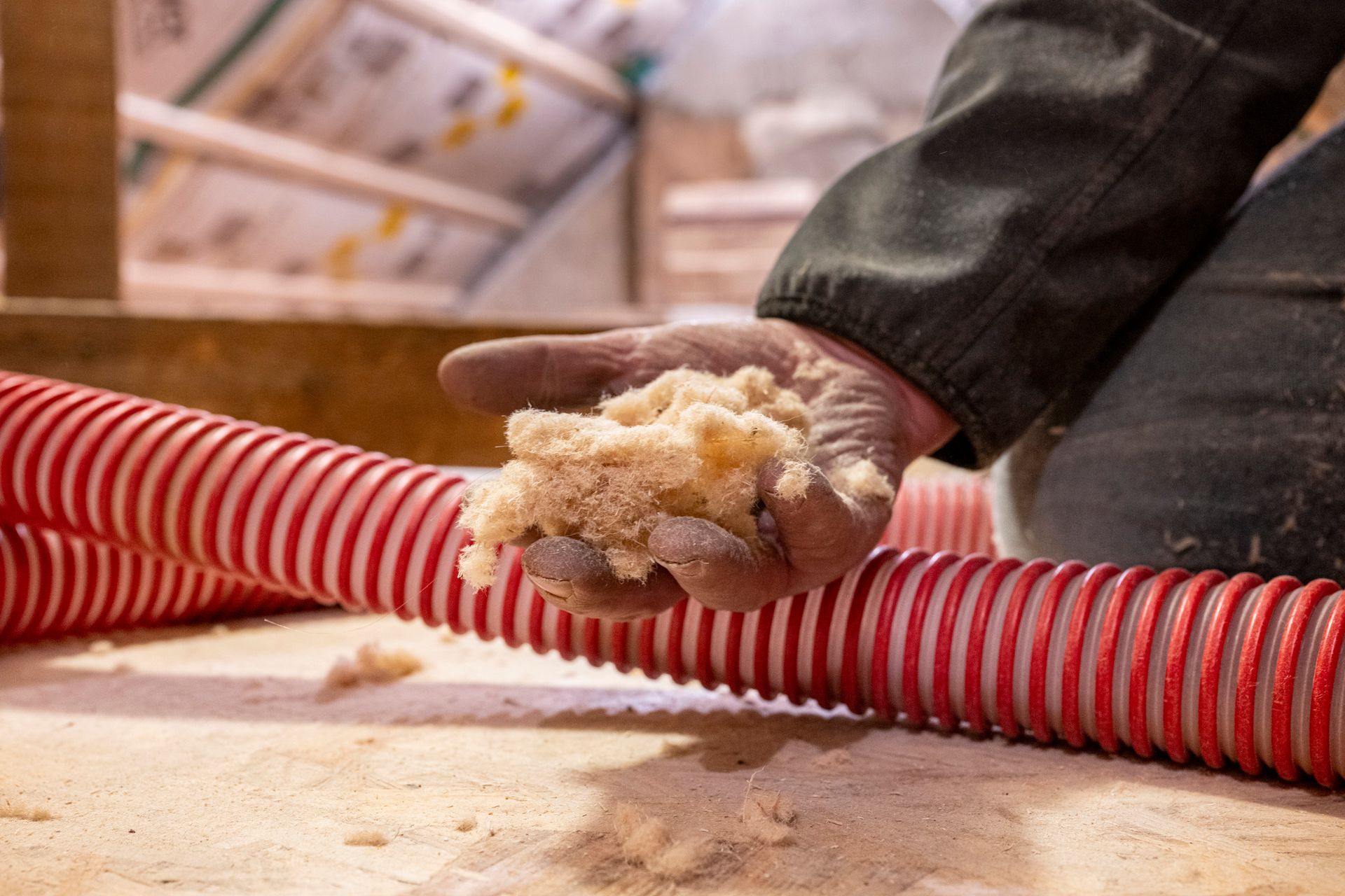 Technician removing old insulation material.