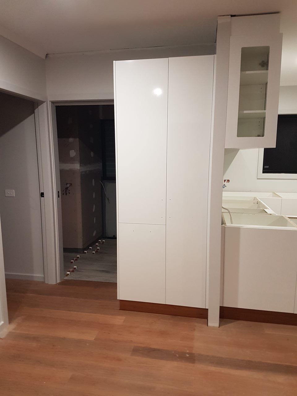 A Man Is Using A Drill To Fix A Screw In A Cabinet — Damn Fine Constructions In Bonville, NSW