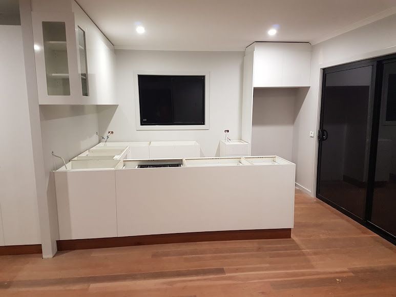 A Kitchen With A Flat Screen Tv On The Wall — Damn Fine Constructions In Bonville, NSW