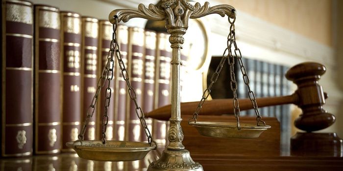 Law books, scales of justice, and gavel on a wooden desk — Benoit Law in Twin Falls, Idaho