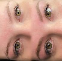 Close-up of two pairs of eyes on a mirrored face, green irises, neutral expression