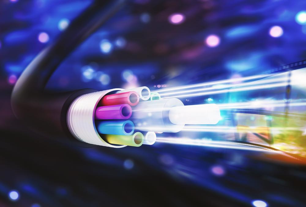 A close up of a fiber optic cable with light coming out of it.