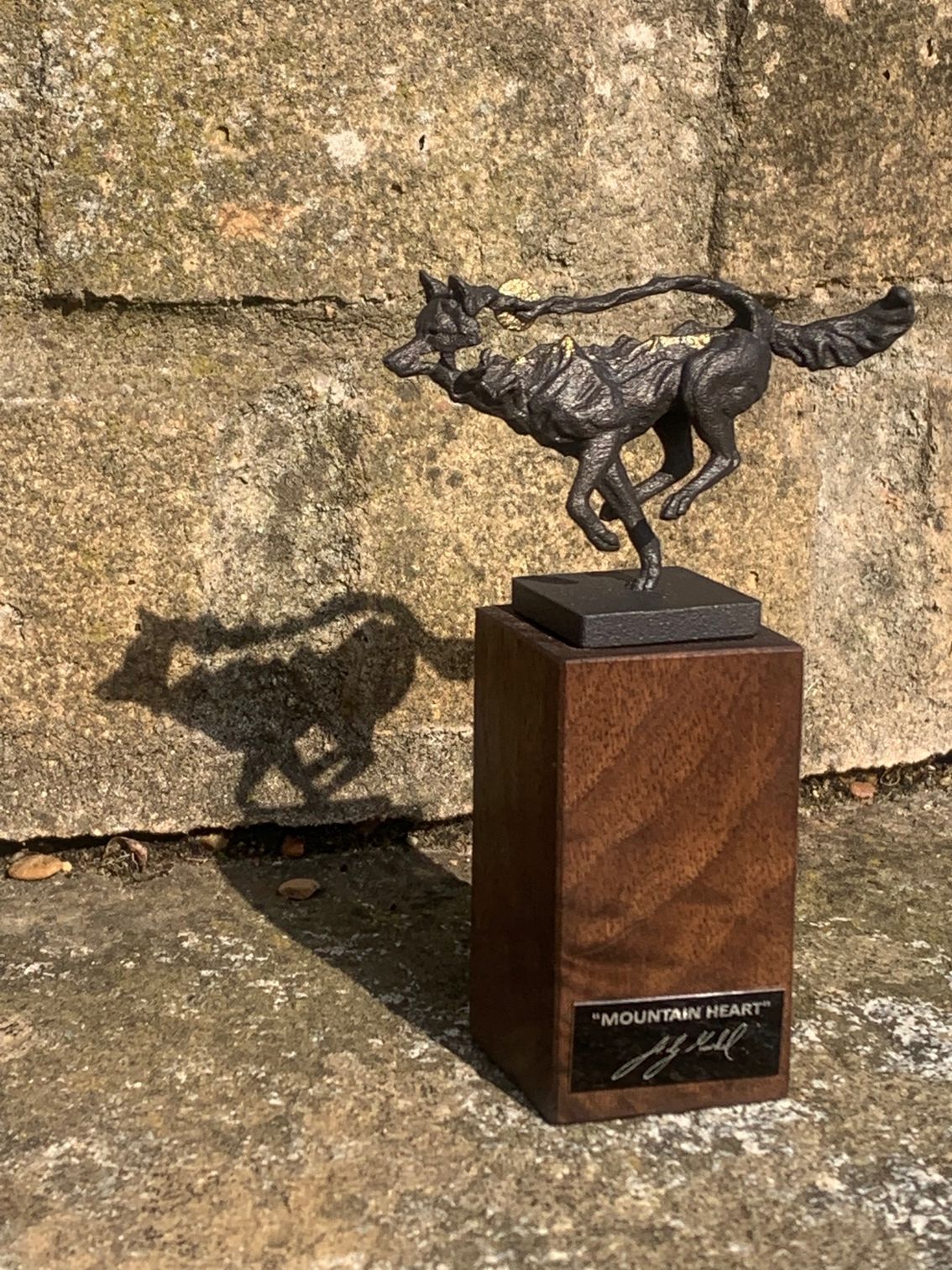 a statue of a wolf is titled 