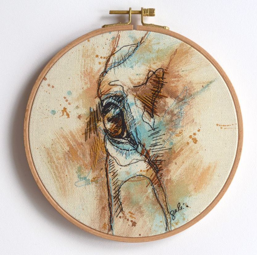 an embroidery hoop with a drawing of a horse 's eye