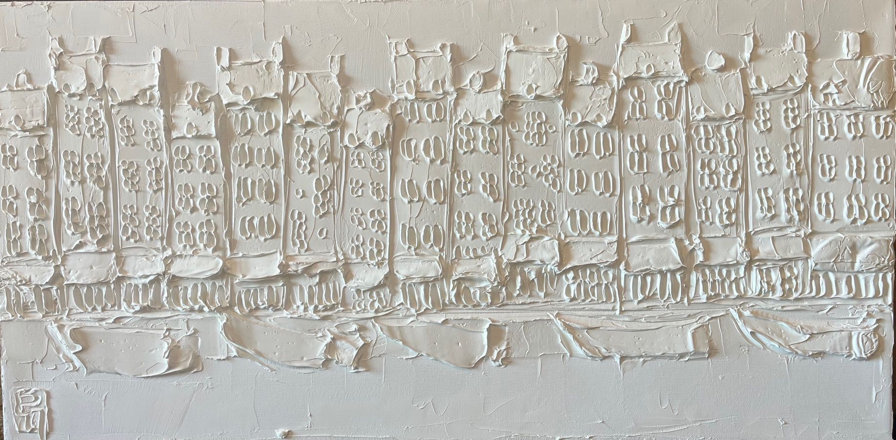Relief carving of canal houses in Amsterdam, white on white.
