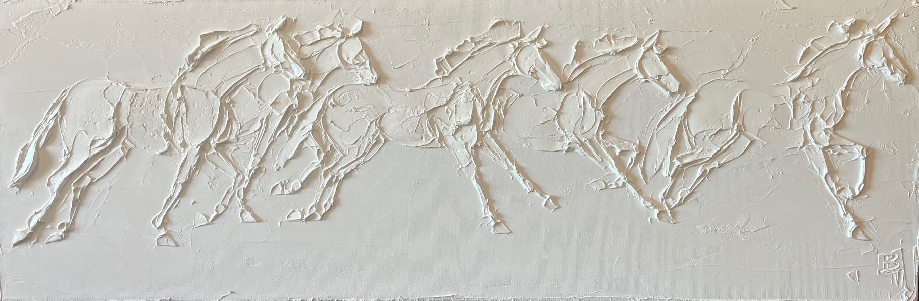 White textured relief of four horses galloping.