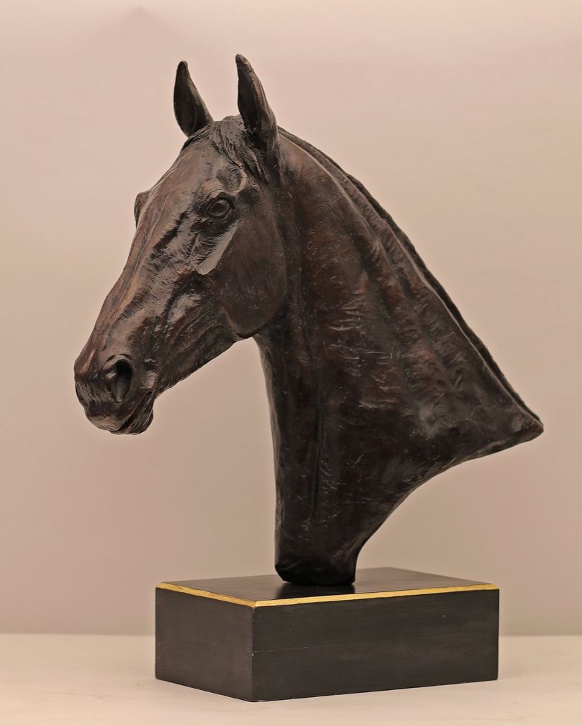 a statue of a horse 's head on a black base