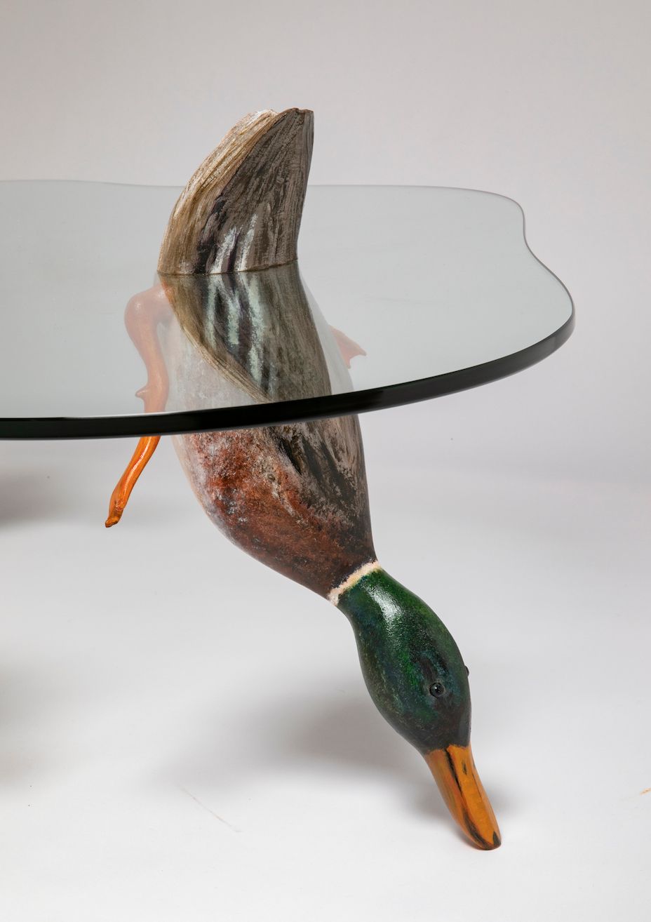 Glass tabletop on sculptural bird-shaped bases with colorful accents