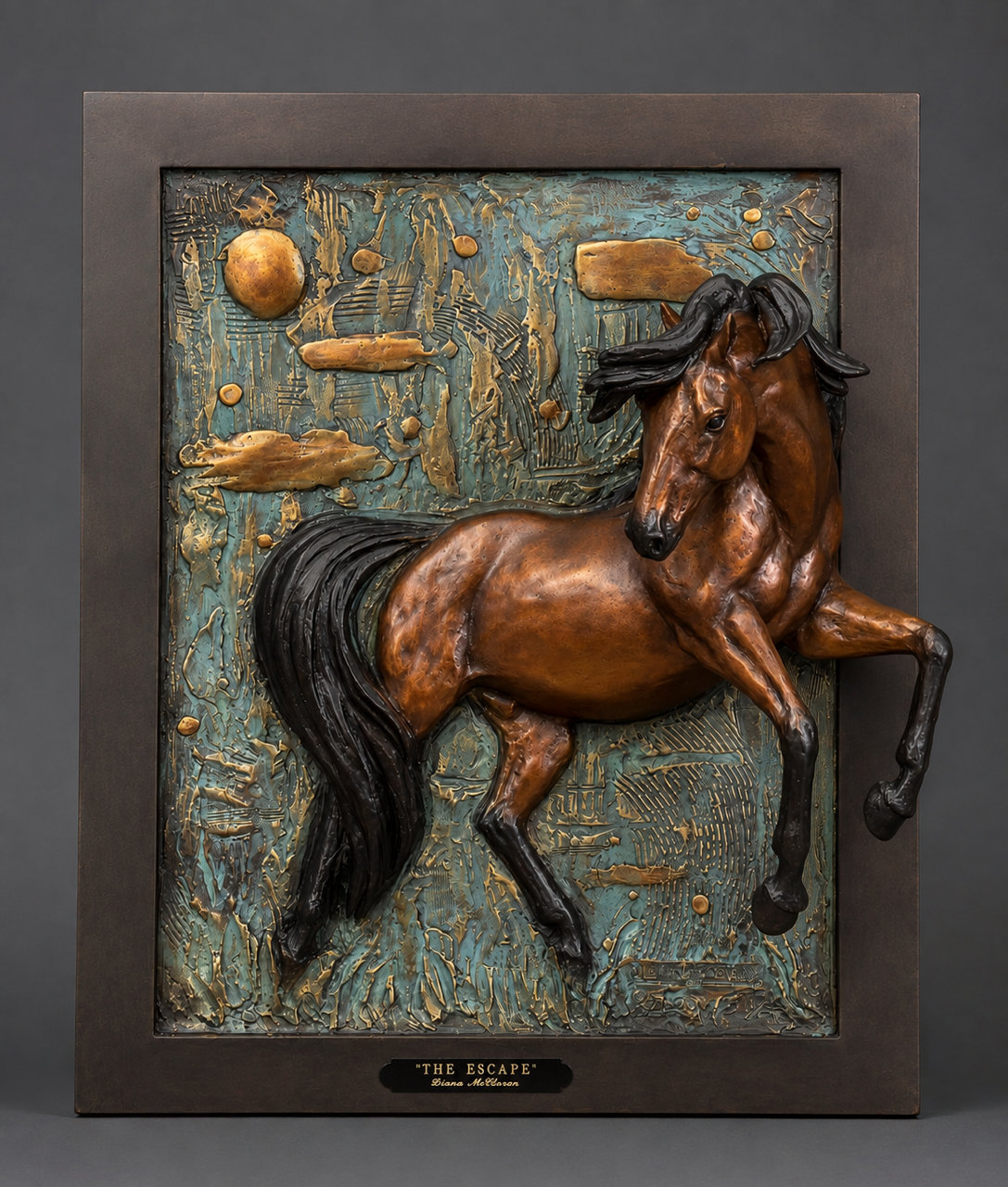 Bronze horse sculpture in a dark frame against a textured beige background.