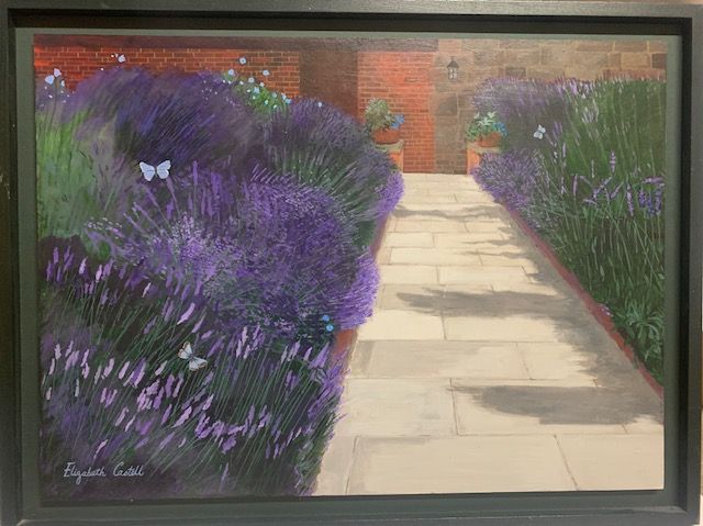 Lavender garden with stone path and brick walls, framed by a dark green border.