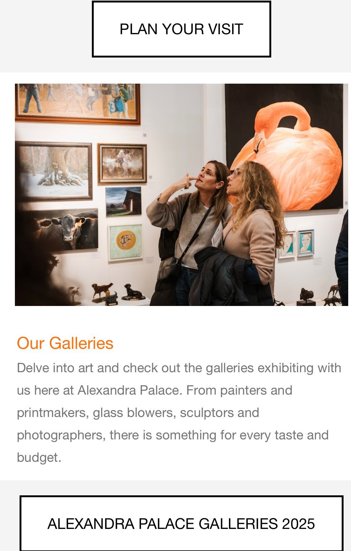 Two women are looking at paintings in a gallery.
