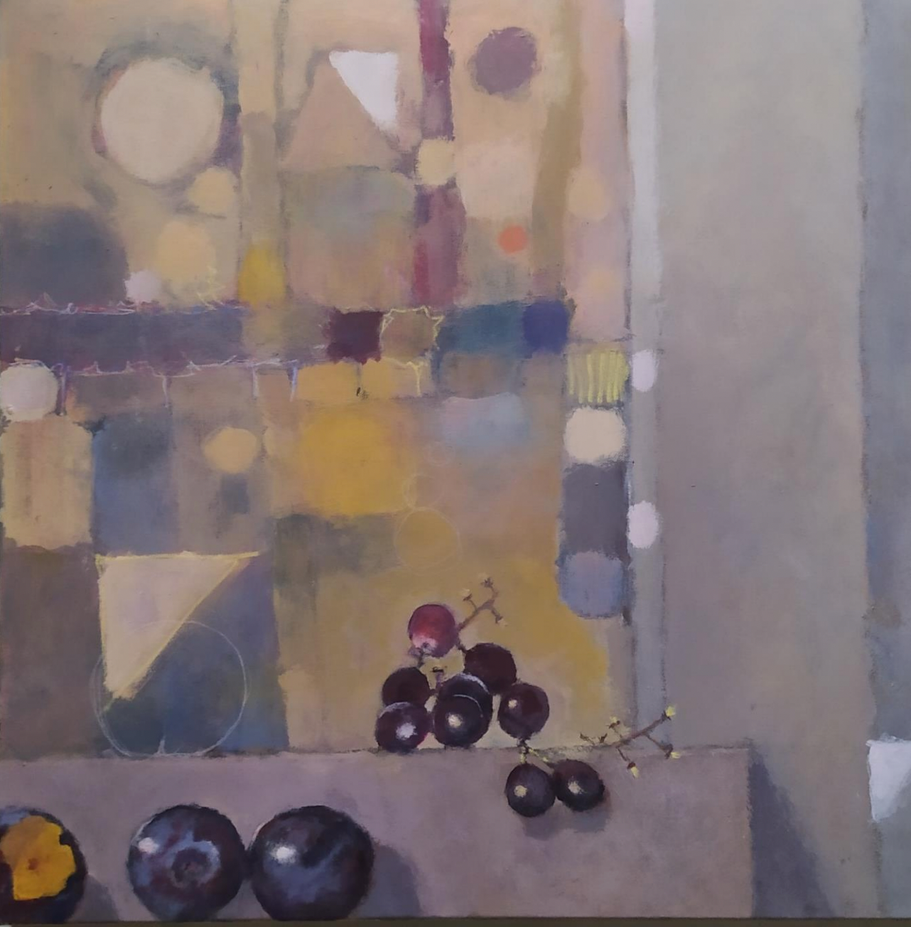 Still life with grapes and plums; abstract background of geometric shapes in muted colors.